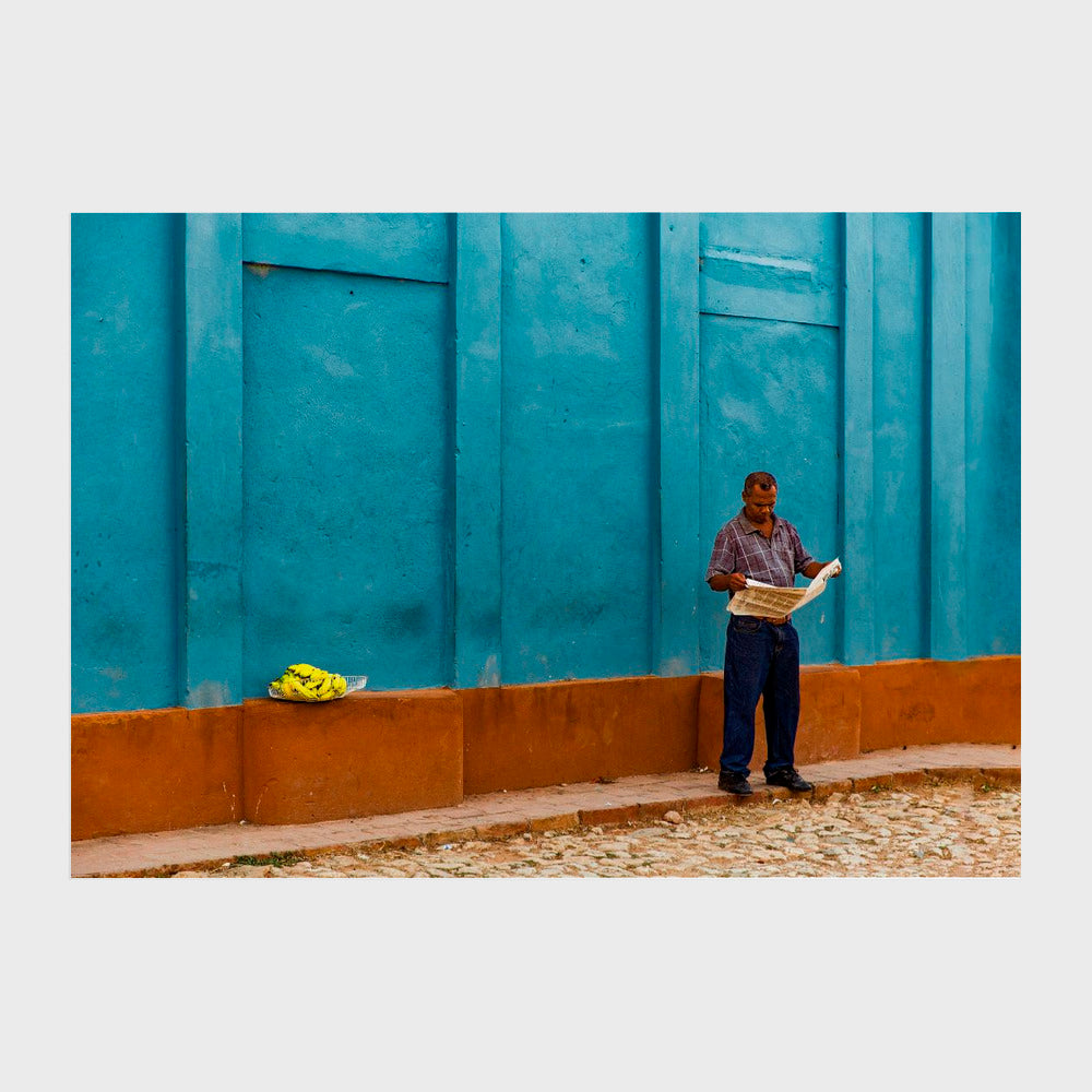 Newspaper reading banana seller